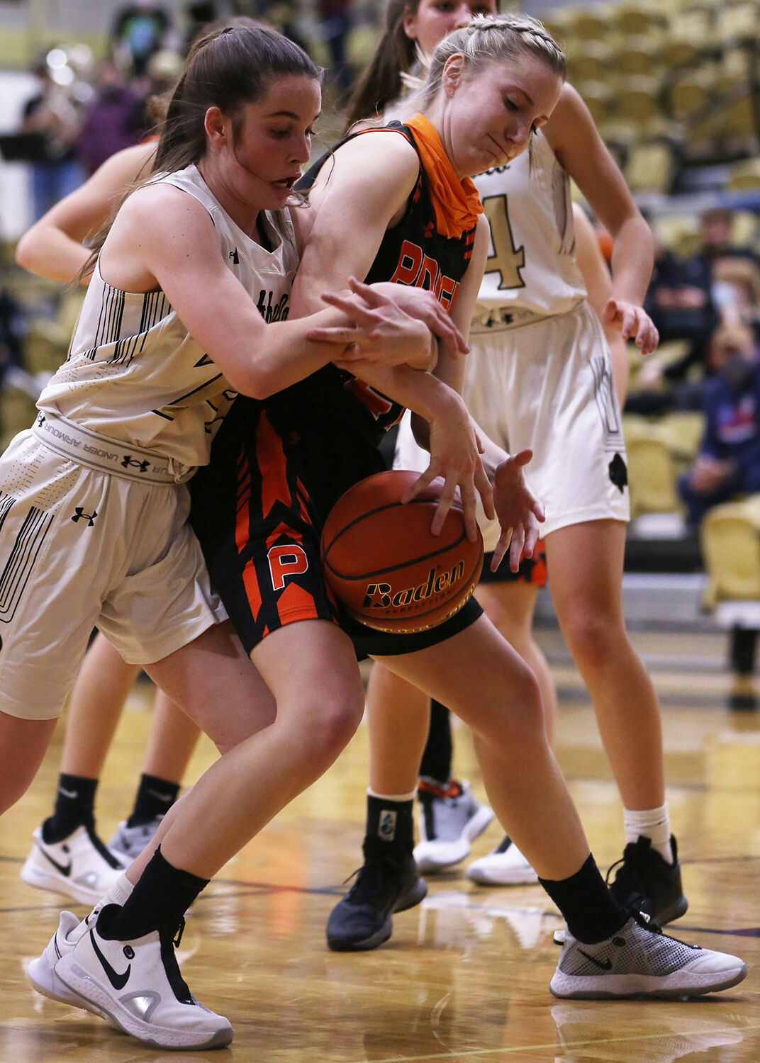 Cassidy Bessler latches onto the arm of Powell senior Hailee Hyde